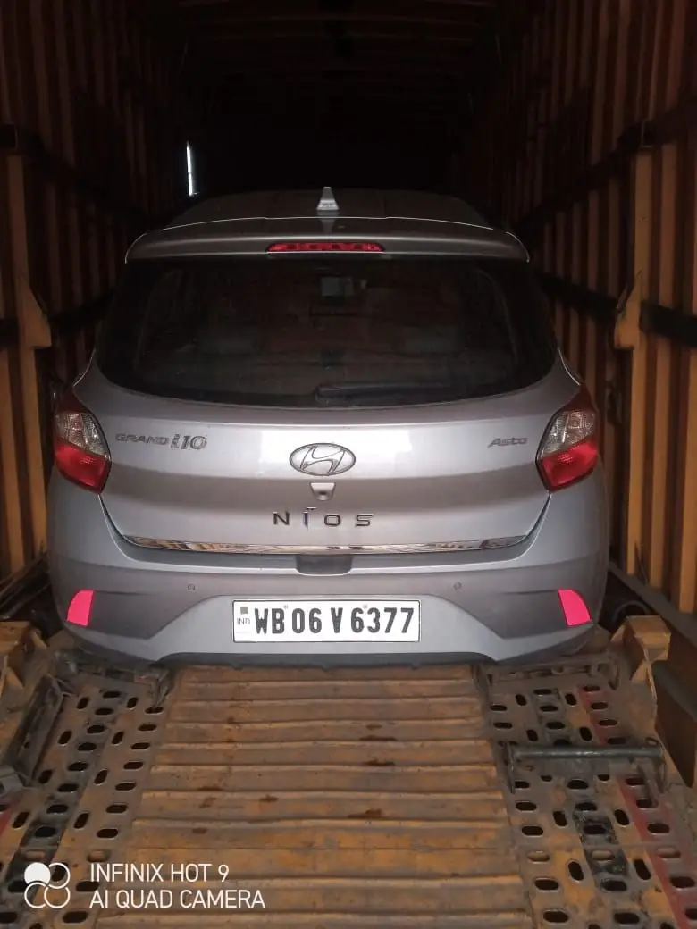 Silver hatchback loaded in the car carrier