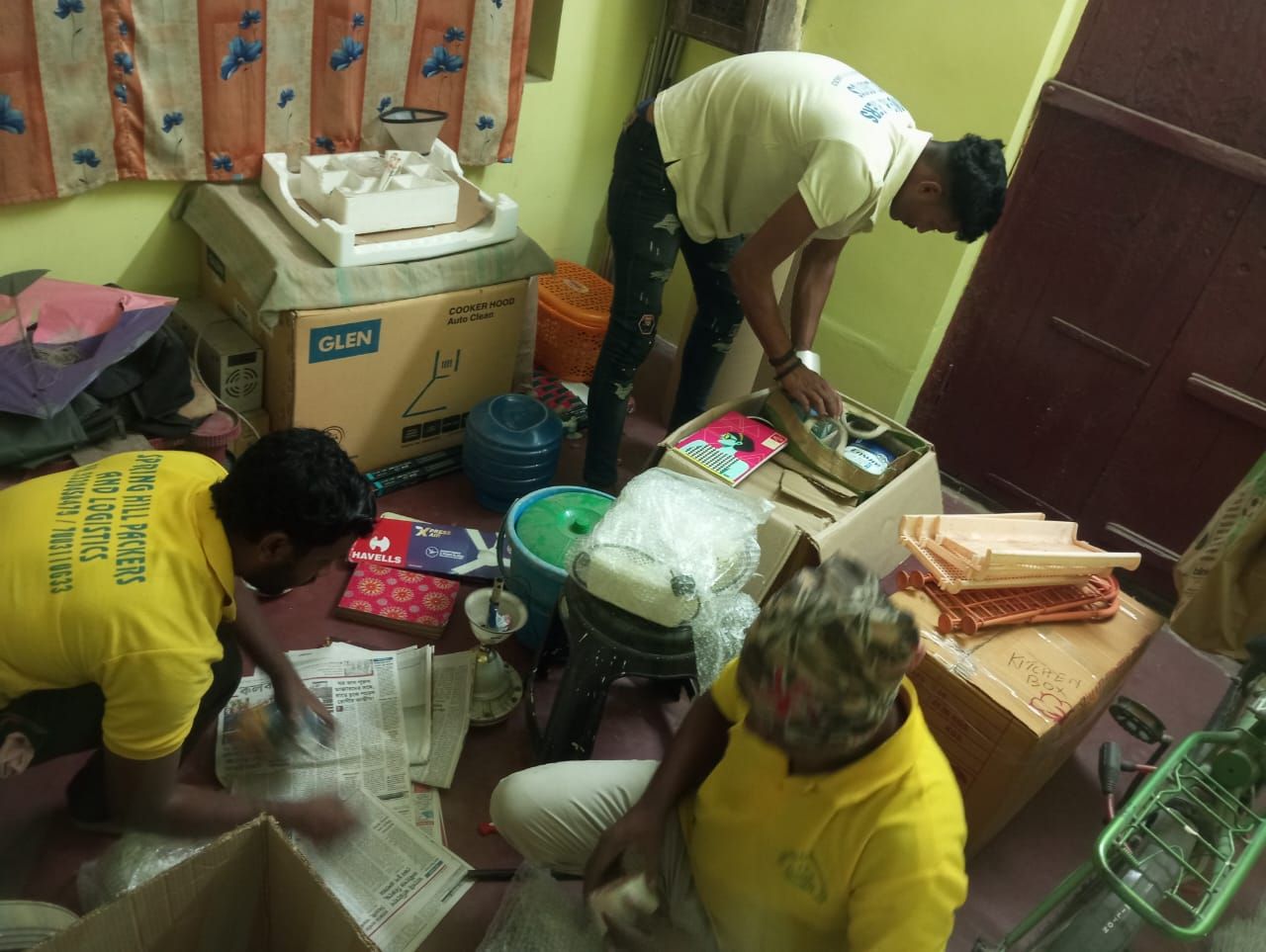 Crew packing kitchen goods into cartons